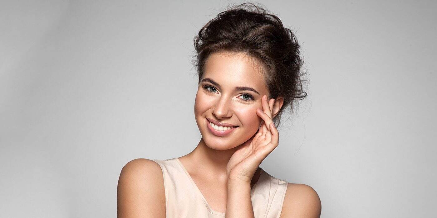 What are Dental Sealants Lady Blushing and give a bright smile .What are Dental Sealants