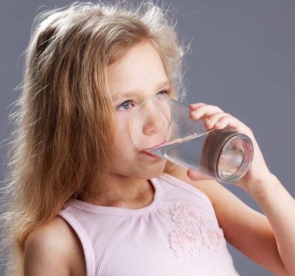Young child drinking water Protecting Baby Teeth