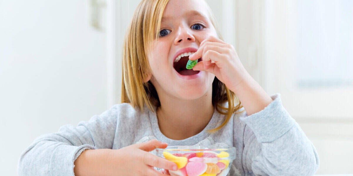girl eating too much sweets a good candidate for kids dental cleaning near me