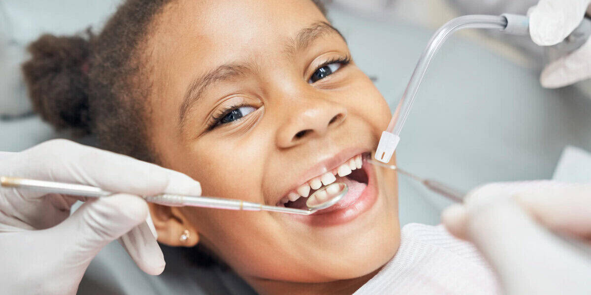 girl-smiling-while-undergoing-affordable-children’s-dental-services girl smiling while undergoing affordable children’s dental services
