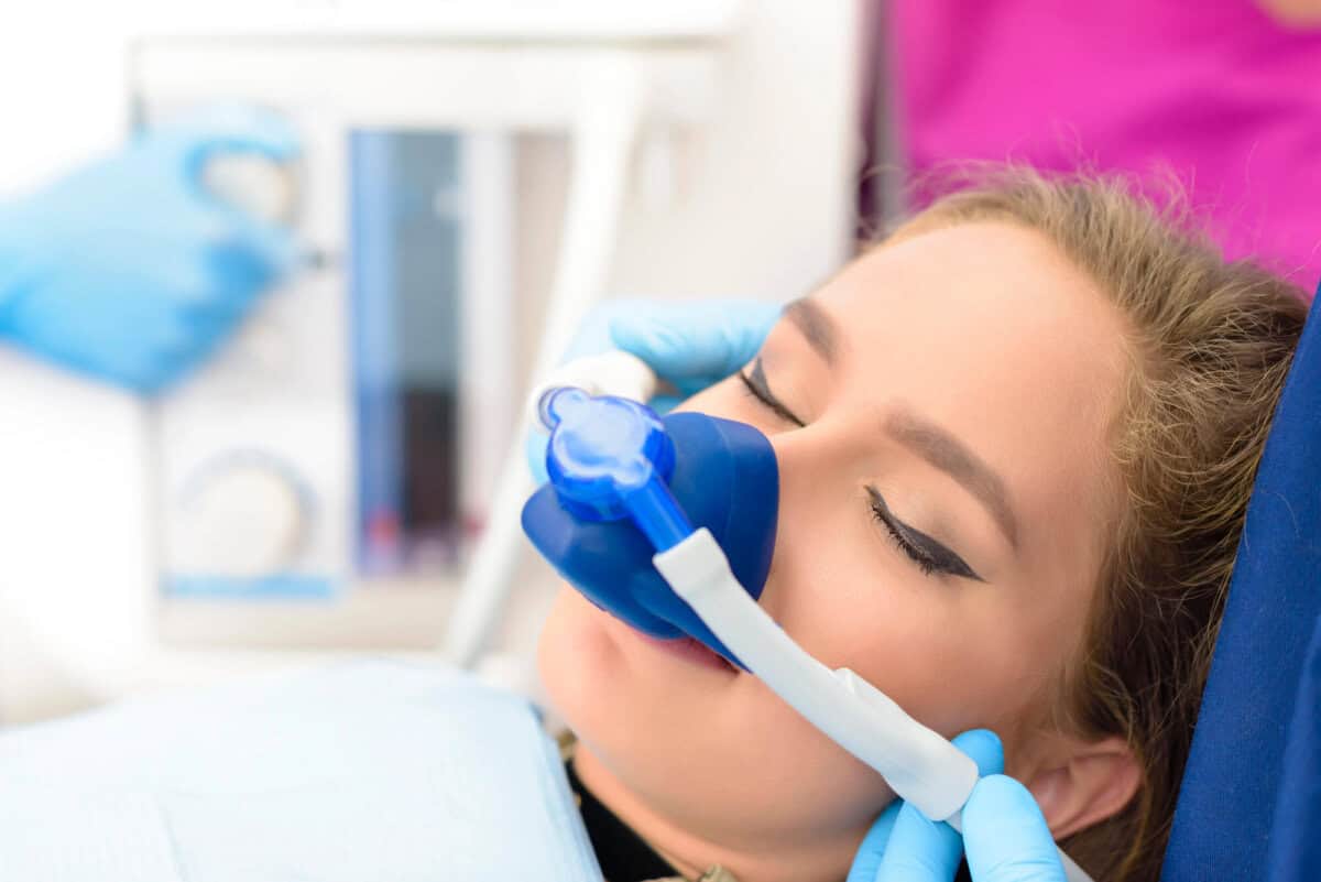 woman sleeping while getting sedation dentistry in Georgia