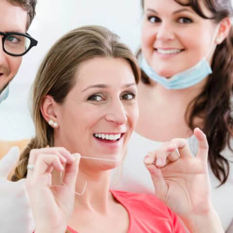 patient geting ready to floss after budget-friendly dental cleanings