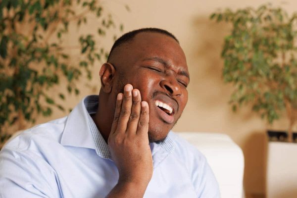 man with impacted wisdom tooth needing Oral Surgery Near Decatur GA